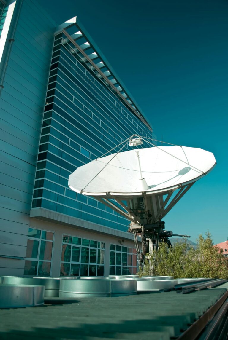 A sleek office building with a large satellite dish in Santiago, Chile.